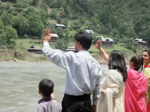 Families wave to their relatives on the Indian side of the Neelum River. (AFP/ File Photo)