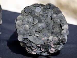 Coins from a late Roman ancient shipwreck found in 2016 off the coast of Israel. Researchers in Greece said Monday pots found from a shipwreck off the eastern Mediterranean coast are about 2,000 years old. (Photo by Abir Sultan/EPA)