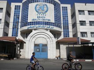 Children ride their bicycles in front of a health centre run by the United Nations Relief and Works Agency (UNRWA) in Gaza City on October 2, 2018, closed in protest against job cuts announced by the UNRWA. (AFP)