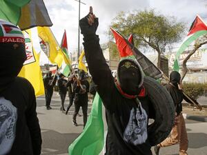Supporters of the Palestinian Fatah movement take part in a rally marking the 55th foundation anniversary of the political party in the West Bank town of Bethlehem on January 1, 2020. Musa AL SHAER / AFP