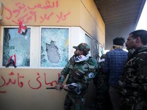 In this file photo taken on December 31, 2019, members the Hashed al-Shaabi, a mostly Shiite network of local armed groups trained and armed by powerful neighbour Iran, smash the bullet-proof glass of the US embassy's windows in Baghdad. (AFP/ File Photo)