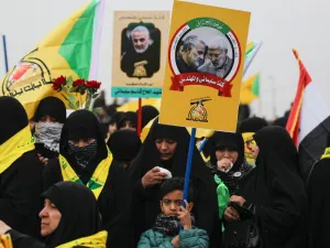 Supporters of the Hashed al-Shaabi paramilitary force and Iraq's Hezbollah brigades attend the funeral of Iranian military commander Qasem Soleimani (portrait) and Iraqi paramilitary chief Abu Mahdi al-Muhandis (portrait) in Baghdad's district of al-Jadriya, in Baghdad's high-security Green Zone, on January 4, 2020.(AFP/ File Photo)