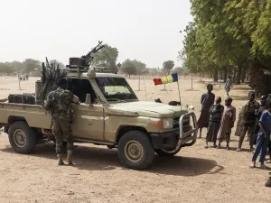 Soldiers of the Chad Army stand next to a Land Cruiser, while bystanders look on, before buing sheep at the Koundoul market, 25 km from N'Djamena, on January 3, 2020, upon their return after a months-long mission fighting Boko Haram in neighbouring Nigeria. (AFP/ File Photo)