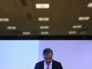 An image taken on a screen in Paris shows former Nissan chief Carlos Ghosn holding a press conference in Beirut on January 8, 2020, the first by the fugitive car magnate since his escape from trial in Japan. Olivier MORIN / AFP