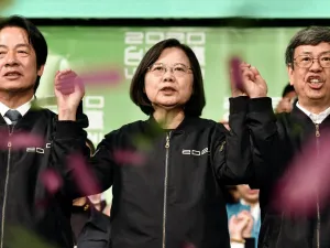 Taiwan President Tsai Ing-wen (C) joins her hands with Vice President-elect William Lai (L) and Vice President Chen Chien-jen outside the campaign headquarters in Taipei on January 11, 2020. President Tsai Ing-wen declared victory in Taiwan's election on January 11 as votes were being counted after an election battle dominated by the democratic island's fraught relationship with China.  Sam Yeh / AFP