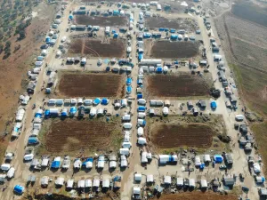 A drone picture taken on January 11, 2020, shows a camp for the displaced on the outskirts of the town of Binnish in Syria’s northwestern province of Idlib. Resident's of Syria's last major opposition bastion welcomed a UN vote renewing cross-border aid to the country, as relief groups condemned restrictions to the programme which is helping millions. The United Nations Security Council on Friday voted to extend humanitarian aid to Syria, including to some of the most needy in the northwestern region of Idl