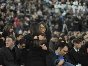 Mourners console each other as they gather at a memorial service for the victims of Ukrainian Airlines flight PS752 crash in Iran at the Saville Community Sports Centre in Edmonton, Canada on January 12, 2020. Walter Tychnowicz / AFP