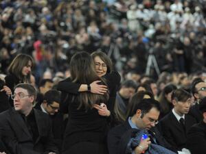 Mourners console each other as they gather at a memorial service for the victims of Ukrainian Airlines flight PS752 crash in Iran at the Saville Community Sports Centre in Edmonton, Canada on January 12, 2020. Walter Tychnowicz / AFP