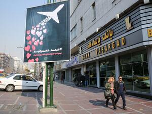 Iranians walk past a poster honouring the victims of a Ukrainian passenger jet accidentally shot down in the capital last week, in front of the Amirkabir University in the capital Tehran, on January 13, 2020. Iran's government denied a "cover-up" after it took days for the armed forces to admit a Ukrainian airliner was shot down by mistake shortly after it took off from Tehran last week, killing all 176 passengers and crew. The plane was brought down hours after Iran had launched missiles at US troops stati
