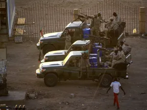 Members of Sudan's intelligence services shoot bullets in the air at the headquarters of the Directorate of General Intelligence Service, in the Riyadh district of the capital Khartoum, on January 14, 2020. Heavy gunfire broke out in Sudanese capital as several agents of the long-feared security agency launched a "rebellion" against a restructuring plan, prompting a closure of the international airport. ASHRAF SHAZLY / AFP