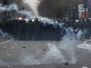  In this file photo taken on December 5, 2019, BRAV police brigades and French gendarmes stand in tear gas during a demonstration against the pension overhauls, in Paris. Zakaria ABDELKAFI / AFP