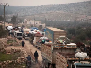 Syrians fleeing towns and villages in the countryside of the northern province of Aleppo drive through the town of Ghazaouia on January 18, 2020, toward safer areas to seek refuge from reported bombing by pro-regime forces. Aaref WATAD / AFP