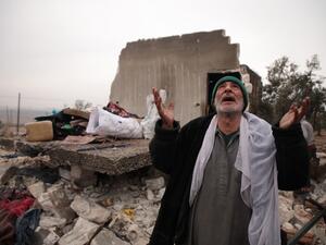 A Syrian man gestures as he stands next to the rubble of the house where he lived with his displaced family in the village of Kafr Taal, in Aleppo's western countryside, after a reported pro-regime bombardment, on January 20, 2020. Aaref WATAD / AFP