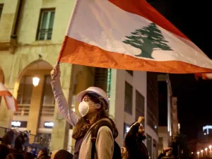 Lebanese protestors wave flags and shout anti-corruption slogans outside the parliament during a protest in downtown Beirut on January 21, 2020. (AFP/ File Photo)