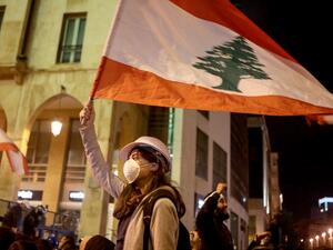 Lebanese protestors wave flags and shout anti-corruption slogans outside the parliament during a protest in downtown Beirut on January 21, 2020. (AFP/ File Photo)