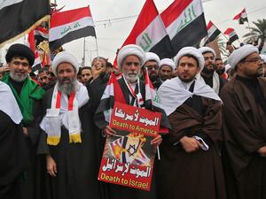 Shiite Muslim clerics carry a placard as supporters of Iraqi cleric Moqtada Sadr gather in the capital Baghdad for a "million-strong" march to demand an end to the presence of US forces in their country, on January 24, 2020. (AFP/ File Photo)