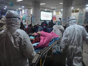In this photo taken on January 25, 2020, medical staff wearing protective clothing to protect against a previously unknown coronavirus arrive with a patient at the Wuhan Red Cross Hospital in Wuhan. (AFP/ File Photo)