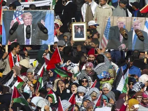 Pro-Palestinian protesters wave Palestinian and Moroccan flags next to posters of the US President Donald Trump and Israeli Prime Minister covered in shoes in a sign of disrespect during a demonstration in Rabat, Morocco on 10 December 2017 [FADEL SENNA/AFP/Getty Images]