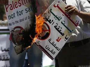 Palestinians protest against Trump's deal of the century in the West Bank city of Ramallah on 2 July 2018 [Abbas Momani/AFP/Getty Images]