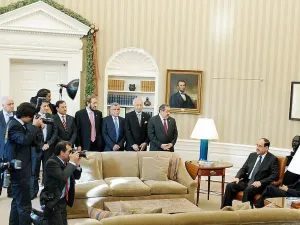 Prime Minister Nouri al-Maliki of Iraq and United States President Barack Obama (seated behind lamp) US President Barack Obama meets Prime Minister Nouri al-Maliki of Iraq at the Oval Office on December 12, 2011. Hadi al Amiri is seen behind the sofa, wearing a blue tie (Shutterstock)	
