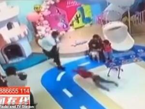 The man savagely flings the boy, causing the child to spin in the air before landing on the floor. (Video Screenshot)