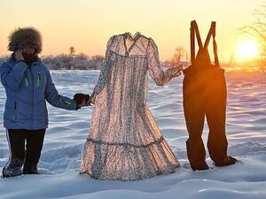 Davydova can be seen holding the clothes, which froze within minutes of being left outdoors, in Yakutia, Siberia last week (dailymail)