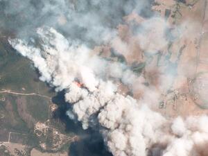 This handout satellite image, taken on December 31, 2019 and received from Planet Labs, Inc. on January 7, 2020, shows smoking rising into the air from bushfires near Lake Conjolia in the Australian state of New South Wales. (AFP)