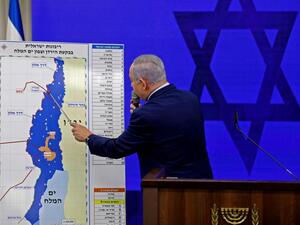 Growing appetite for lands. Israeli Prime Minister Binyamin Netanyahu points at a map of the Jordan Valley as he gives a statement in Ramat Gan near Tel Aviv, September 10. (AFP)