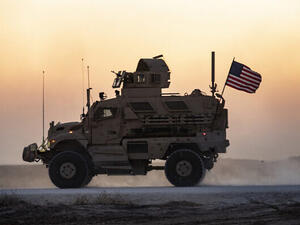 A US military vehicle, part of a convoy, drives near the town of Tal Tamr in the northeastern Syrian Hasakeh province on the border with Turkey, November 10, 2019. (Delil Souleiman/AFP)