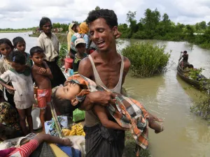 A Rohingya refugee reacts while holding his dead son after crossing the Naf river from Myanmar into Bangladesh in Whaikhyang on Oct. 9, 2017. (Indranil Mukherjee/AFP/Getty Images)