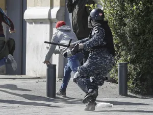 Anti-government protesters throw stones during clashes with security forces amidst a demonstration in the centre of the Lebanese capital Beirut on January 27, 2020. JOSEPH EID / AFP