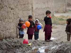 Children play with balloons along a street in Kandahar Province on January 28, 2020. JAVED TANVEER / AFP