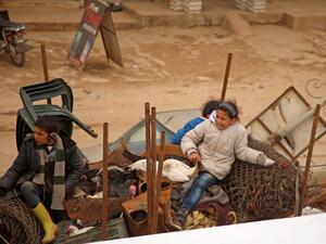Displaced Syrian children sit in the back of a truck transporting their belongings as they pass through the town of Hazano in the northern countryside of Idlib, on February 4, 2020, fleeing northwards amid an ongoing regime offensive. A Russian-backed Syrian government offensive against the country's last rebel enclave of Idlib has displaced more than half a million people in two months, according to the United Nations. The wave of displacement, which coincides with a biting winter, is one of the largest si