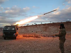 A Syrian rebel fighter fires a Grad rocket towards government forces in northwestern Syria on February 8, 2020. Since December, government forces have pressed a blistering assault against the Idlib region with Russian support, retaking town after town despite warnings from rebel ally Turkey to back off. Omar HAJ KADOUR / AFPq