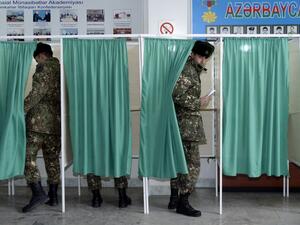 Azerbaijan's servicemen vote at a polling station during the parliamentary elections in Baku on February 9, 2020. Azerbaijan on Sunday holds snap parliamentary elections denounced by opposition parties as a feint aimed at further strengthening authoritarian President Ilham Aliyev's tight grip on power. TOFIK BABAYEV / AFP