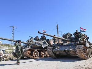 Syrian army units advance in the town of al-Eis in south Aleppo province on February 9, 2020, following battles with rebels and jihadists. Al-Eis, which overlooks the M5, was on a front that saw fierce fighting between the regime and its opponents in 2016. Syrian troops advancing north of Idlib linked up near Al-Eis with their comrades pushing south of Aleppo, state news agency SANA said. The two units had recently waged separate battles in rural Aleppo and southern Idlib, but are now conjoined for the firs