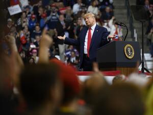 US President Donald Trump looks at his supporters after reading words from Al Wilson's song "The Snake" during a rally in Manchester, New Hampshire on February 10, 2020. JIM WATSON / AFP