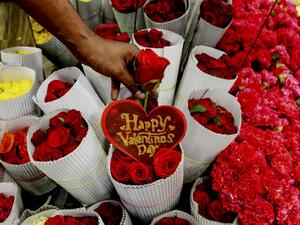 A florist arranges roses flowers at a shop ahead of Valentine's Day in Chennai on February 11, 2020. Arun SANKAR / AFP