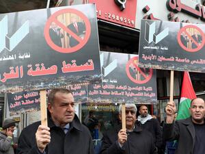 Palestinian protesters hold placards that read in Arabic: "No to the Deal of the Century", as they demonstrate against a US-brokered peace proposal in the West Bank city of Ramallah, on February 11, 2020. AFP