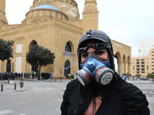 A Lebanese protester poses for a picture with a gas mask near clashes with security forces during a protest in the heart of Beirut to stop a confidence vote for a new government, which they say fails to address their demands and cannot rescue the ailing country, on February 11, 2020. Lebanon has been rocked by protests since October 17 demanding a complete overhaul of a political class which activists say is inept, corrupt and motivated by personal gain. ANWAR AMRO / AFP