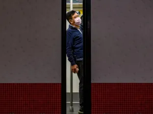 A man wears a face mask as a preventative measure against the COVID-19 coronavirus, as he stands in a train at Mong Kok MTR station in Hong Kong on February 14, 2020. The death toll from China's virus epidemic neared 1,400 on Friday with six medical workers among the victims, underscoring the country's struggle to contain a deepening health crisis. Philip FONG / AFP