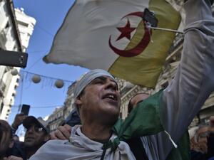 Algerians chant slogans as they march in an anti-government demonstration in the capital Algiers on February 14, 2020. RYAD KRAMDI / AFP