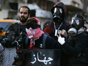 Iraqi protesters wear protective masks during clashes with riot police following an anti-government demonstration in the capital Baghdad's Al-Khilani Square, on February 14, 2020. AHMAD AL-RUBAYE / AFP