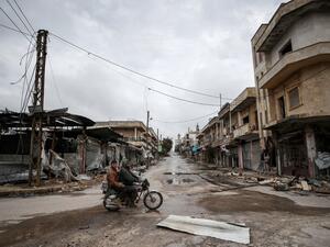 Syrians ride a motorbike in the deserted city of Kafranbel, south of Idlib city in the eponymous northwestern Syrian province, on February 15, 2020, amid an ongoing pro-regime offensive. Omar HAJ KADOUR / AFP