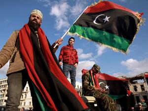 Libyans wave their national flag as they take part in a celebration marking the Libyan revolution, which toppled strongman Moamer Kadhafi, in Benghazi on February 17, 2020. Abdullah DOMA / AFP 