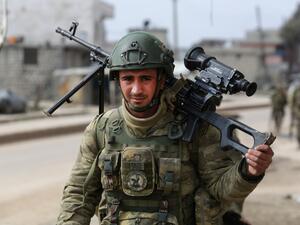 A Turkish soldier patrols with troops in the town of Atareb in the rebel-held western countryside of Syria's Aleppo province on February 19, 2020. AFP
