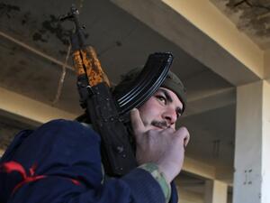 A Turkish-backed Syrian fighter carries a riffle at a position east of Idlib city in northwestern Syria on February 20, 2020 amid ongoing regime offensive on the last major rebel bastion in the country's northwest.  Bakr ALKASEM / AFP