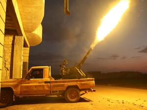 Turkish-backed Syrian fighters fire their anti-aircraft gun in the town of Sarmin, about 8 kilometres southeast of the city of Idlib in northwestern Syria, on February 24, 2020, as they take part in a military offensive on the village of Nayrab following an artillery barrage fired by Turkish forces. Omar HAJ KADOUR / AFP