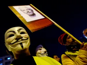 Demonstrators sporting Guy Fawkes masks take part in a protest called by Catalan National Assembly (ANC) under the motto "Journalism is not a crime" to support WikiLeaks founder Julian Assange in Barcelona on February 24, 2020. LLUIS GENE / AFP