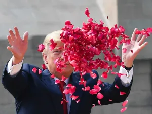 US President Donald Trump sprays rose petals to pay tribute at Raj Ghat, the memorial for Indian independence icon Mahatma Gandhi, in New Delhi on February 25, 2020. Mandel NGAN / AFP
